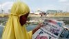 BINLADEN-ANNIVERSARY / Where is Al-Qaeda today / A Muslim woman reads an article about the death of international terrorist leader Osama bin Laden on the front page of a local newspaper in Manila May 3, 2011. 