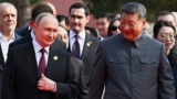 Russian President Vladimir Putin and Chinese President Xi Jinping arrive at a military parade in Beijing on September 3.