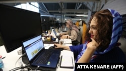 Employees work at headquarters housing Alibaba, Iran's largest online travel booking service, in the capital Tehran on February 17, 2020