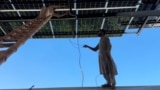 Workers install Chinese-made solar panels in Pakistan's Khyber Pakhtunkhwa province.