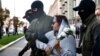 A woman is detained by security forces in Minsk on September 26. 