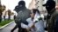 A woman is detained by security forces in Minsk on September 26. 