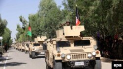 Afghan National Army soldiers perform during a ceremony to mark Independence Day, in Kandahar, August, 2015.