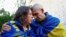 Ukrainian prisoner of war Oleksandr embraces his wife Olena after being returned to Ukraine in a prisoner swap, May 23, 2025.