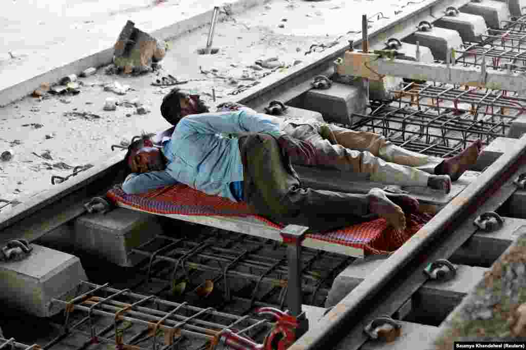 Workers sleep on a railway track under repair in New Delhi, India. (Reuters/Saumya Khandelwal)