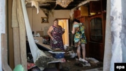 Local residents in Donetsk return to homes damaged by shelling in August.