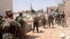 Syria -- Government forces carry their weapons as they move during what they said was an operation to push rebels from the road between Dahra Abd Rabbo village and Castello in Aleppo, 27May2013