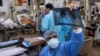 Rohan Aggarwal, 26, a resident doctor treating patients suffering from the coronavirus disease (COVID-19), looks at a patient's x-ray scan during his 27-hour shift at Holy Family Hospital in New Delhi, India, May 1, 2021.