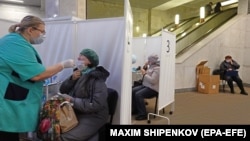 A woman undergoes COVID-19 testing at a "coronavirus express test point" in a subway station in Moscow on November 3. 