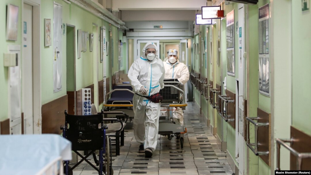 Medical workers move a patient on a trolley inside a hospital where patients suffering from COVID-19 are treated in Moscow.