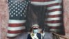 An Iranian Army soldier stands in front of a picture of a burned U.S. flag during an anti-American demonstration marking the the 42nd anniversary of the U.S. Embassy takeover, in front of the former U.S. Embassy in Tehran, on November 4.&nbsp;