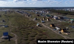 A drone photograph shows houses on a former airfield, where the terrain is typical of thermokarst.