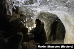 Sergei Zimov checks materials stored underground in the permafrost.