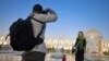 Iran, Isfahan -- Two young tourists vising Isfahan historic sites, undated. File photo