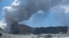 NEW ZEALAND - This handout photograph courtesy of Michael Schade shows the volcano on New Zealand's White Island spewing steam and ash minutes following an eruption on December 9, 2019.