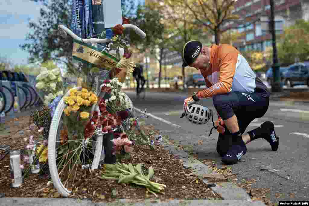 A man prays after laying flowers at a &quot;ghost bike&quot; memorial that is now used to remember the victims of the deadly October 31 terrorist attack along a bike path in New York City. (AP/Andres Kudacki)