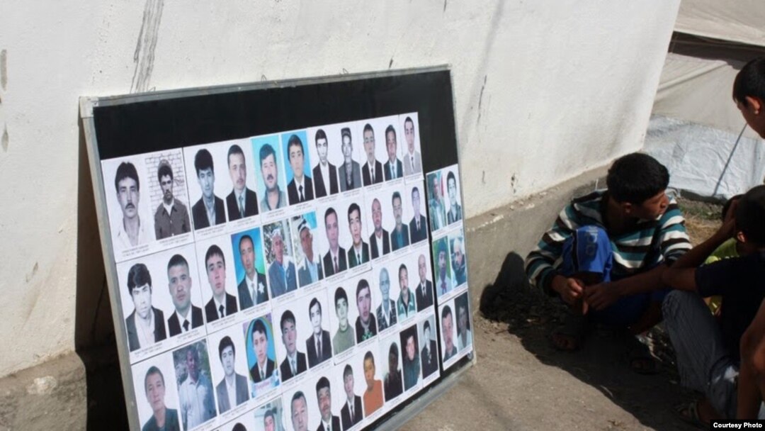 A board in the southern Kyrgyz city of Osh displays pictures of ethnic Uzbek men killed during the ethnic clashes in June.