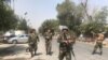 Security forces are seen near the site where a suicide bomber blew himself up in the center of Kabul on September 5. 