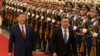 Chinese President Xi Jinping (left) and Kyrgyzstan's Sadyr Japarov pass an honor guard during a Beijing ceremony in February 2025.