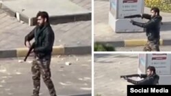 یکی از اعضای گردان‌های امنیتی امام علی بسیج اصفهان در حال تیراندازی با سلاح ساچمه‌زنی به سمت معترضان
