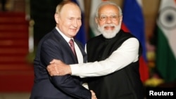 Russia's President Vladimir Putin shakes hands with India's Prime Minister Narendra Modi in New Delhi in December 2021.