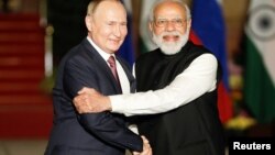 Russia's President Vladimir Putin (left) shakes hands with India's Prime Minister Narendra Modi in New Delhi on December 6.