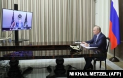 The flip side: Putin is seen speaking with Biden on the video call from the Black Sea resort of Sochi on December 7.