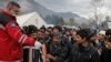 Migrants queue for free shoes delivery inside Vucjak camp near Bihac on November 15.