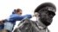 A municipal worker cleans a statue of Soviet World War II hero Marshal Georgy Zhukov in St. Petersburg in preparation for Victory Day festivities.