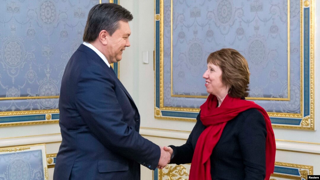 Ukrainian President Viktor Yanukovych (left) shakes hands with EU foreign-policy chief Catherine Ashton during a meeting in Kyiv on January 29.