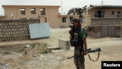 A member of an Afghan commando unit stands guard in a Kunduz district. (file photo)