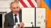 Armenian Prime Minister Nikol Pashinian holds a signed trilateral declaratoin during a ceremony with Azerbaijani President Ilham Aliyev and U.S. President Donald Trump at the White House, Washington, August 8, 2025.