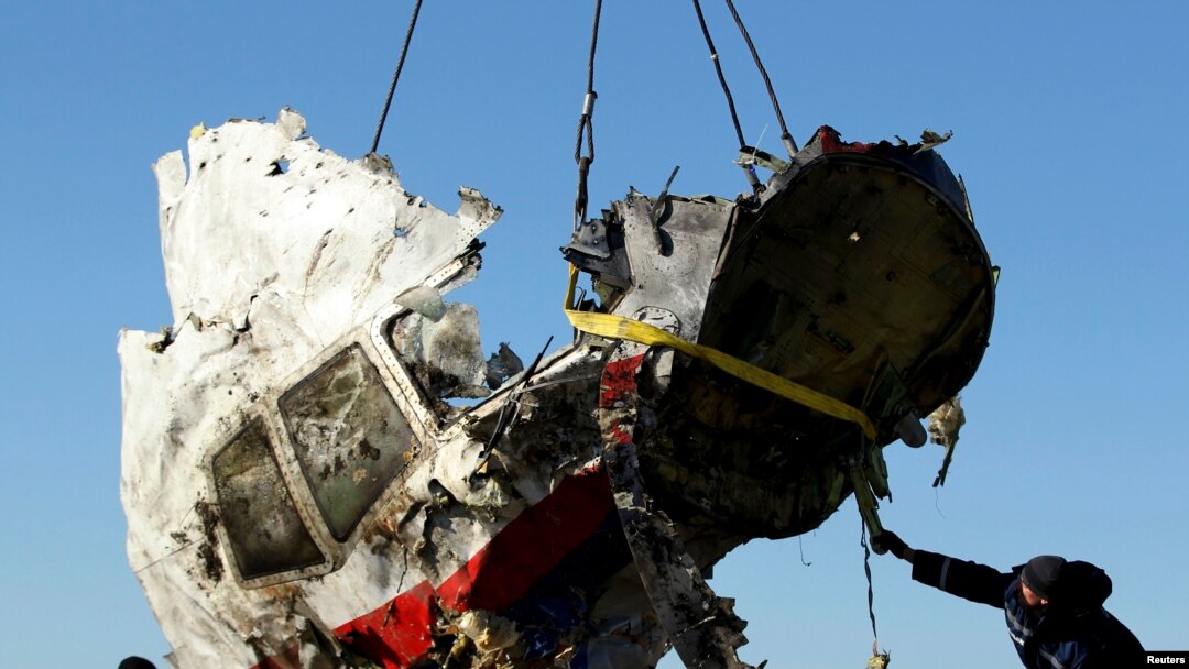 Local workers transport a piece of wreckage from Malaysia Airlines flight MH17 in the Donetsk region, where the plane was shot down in 2014, killing all 298 people on board.