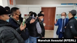 Supporters of Kazakh activist Qanat Zhaqypov gather outside the courtroom for his February 23 court hearing, which they were not allowed to attend.