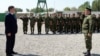 Kyrgyz President Sooronbai Jeenbekov (left) with members of the country's border guards (file photo)