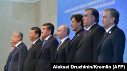 Leaders of the SCO countries pose for on June 14.