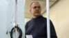 Paul Whelan stands inside a defendants' cage as he attends a court hearing regarding the extension of his detention in Moscow on May 24.