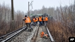 Russian Railways crews work at the scene of derailed cargo carriages in the Ryazan region in November 2023. 