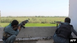 Afghan police keep watch to prevent a Taliban attack in the Imam Sahib District of northern Kunduz province, in August.