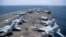 US Navy sailors work on the flight deck of the aircraft carrier USS George Washington as it transits the Arabian Sea near the Strait of Hormuz on August 20. 