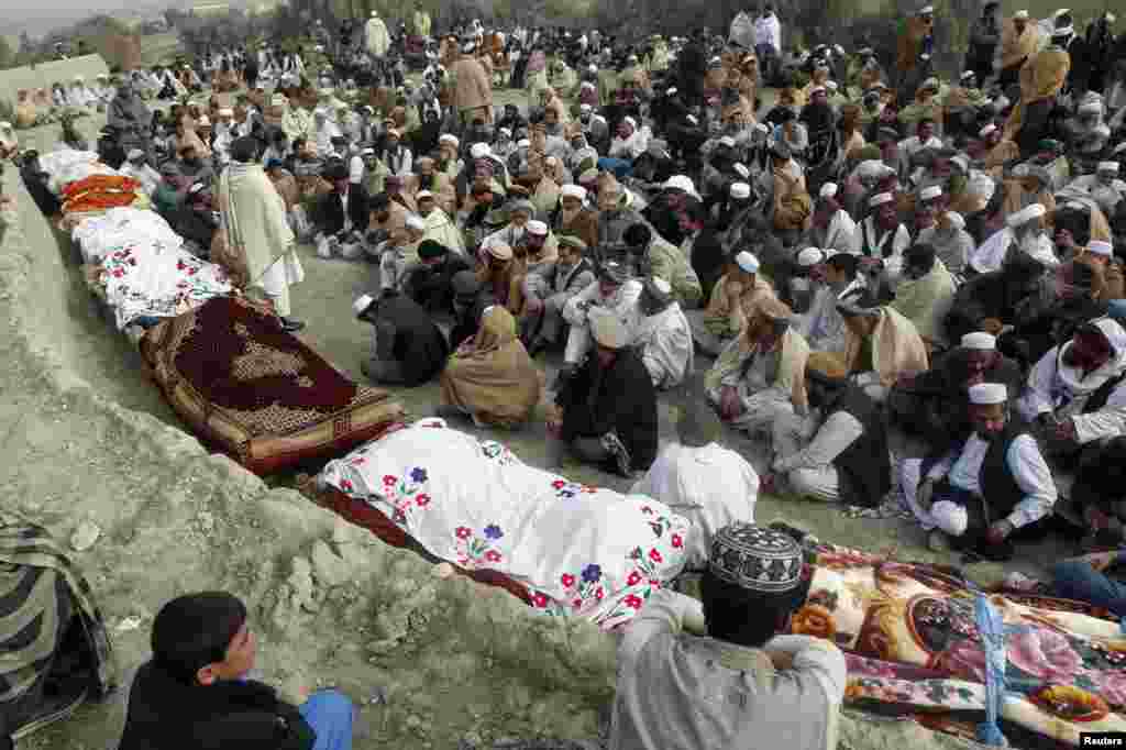 Villagers mourn over the bodies of 10 girls between 9 and 11 years old who were killed by an explosion in Jalalabad, in eastern Afghanistan, as they were collecting firewood. (Reuters/Parwiz)