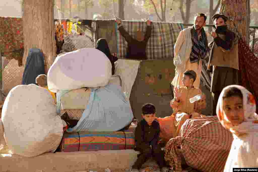 Displaced Afghan families sit with their belongings at the shelter in Kabul&#39;s Shahr-e Naw park on October 4 as they prepare to return to their provinces.