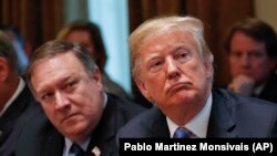 President Donald Trump, right, and Secretary of State Mike Pompeo, left, listen to Ivanka Trump, the daughter and assistant to President, speaks during his meeting with members of his cabinet in Cabinet Room of the White House in Washington, Wednesday, Ju