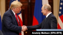 U.S. President Donald Trump (left) and Russian President Vladimir Putin shake hands during a joint press conference following their summit talks in Helsinki in July 2018.