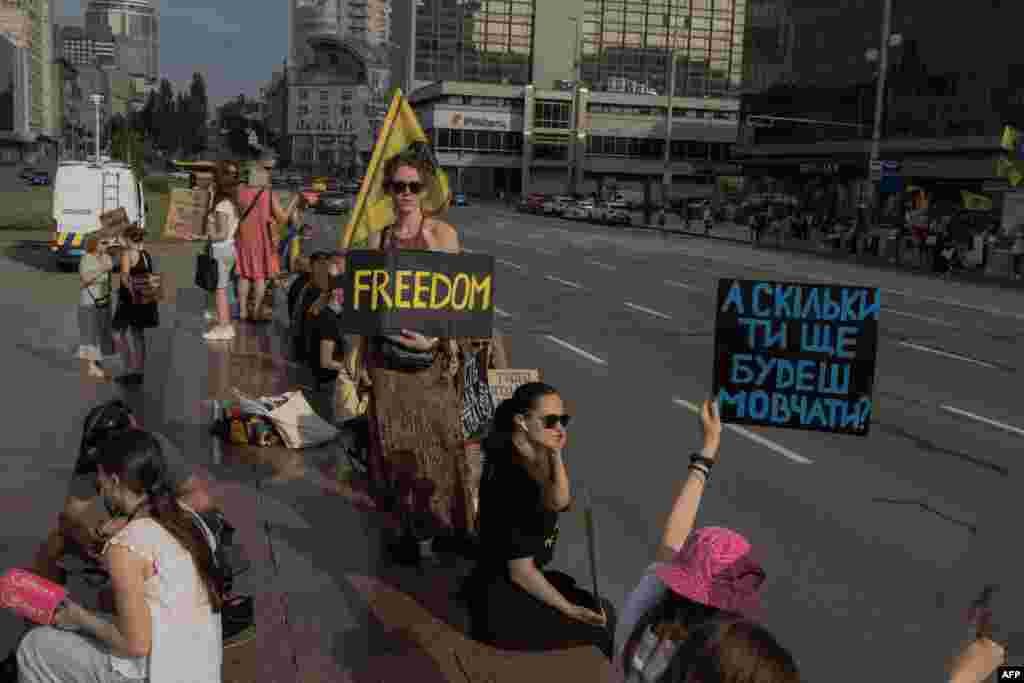 Campaigners hold placards during a rally to raise awareness about the fate of Ukrainian prisoners of war from the Azov Brigade and other military units, in Kyiv, on August 10.