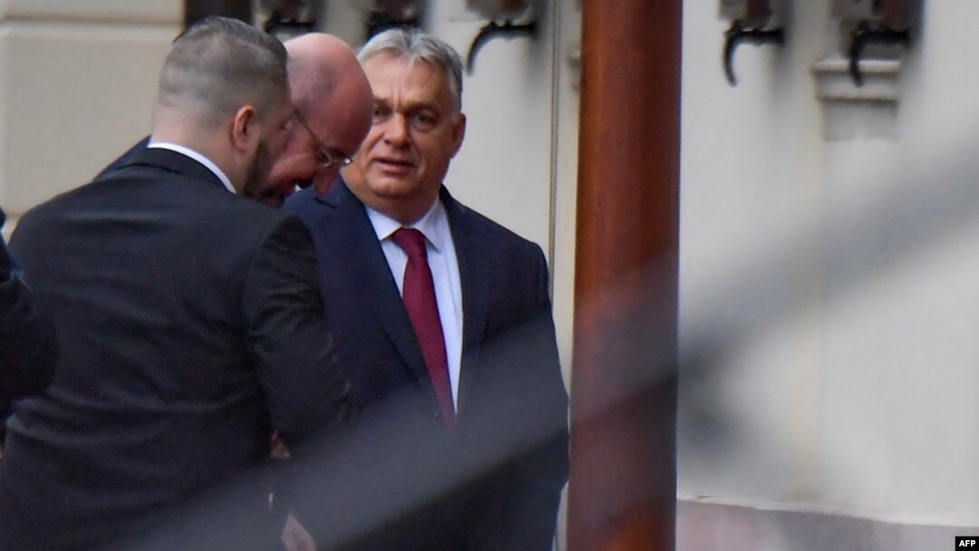 Hungarian Prime Minister Viktor Orban (right) greets Charles Michel, the president of the European Council, on his arrival for a meeting in Budapest on November 27.