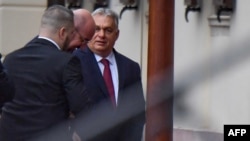 Hungarian Prime Minister Viktor Orban (right) greets Charles Michel, the president of the European Council, on his arrival for a meeting in Budapest on November 27.