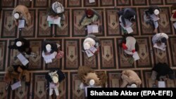 Pakistani and foreign religious students take exams at the Jamia Binoria Aalamia madrasah in Karachi.