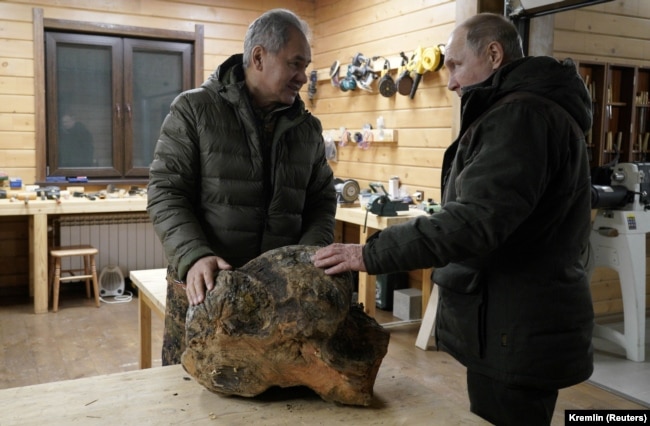 Владимир Путин и Сергей Шойгу в мастерской резьбы по дереву во время отдыха в тайге, 21 марта 2021 года