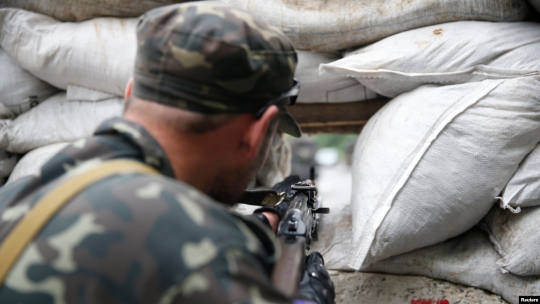 A pro-Russian fighter mans a checkpoint in the eastern Ukrainian city of Donetsk on July 7. 